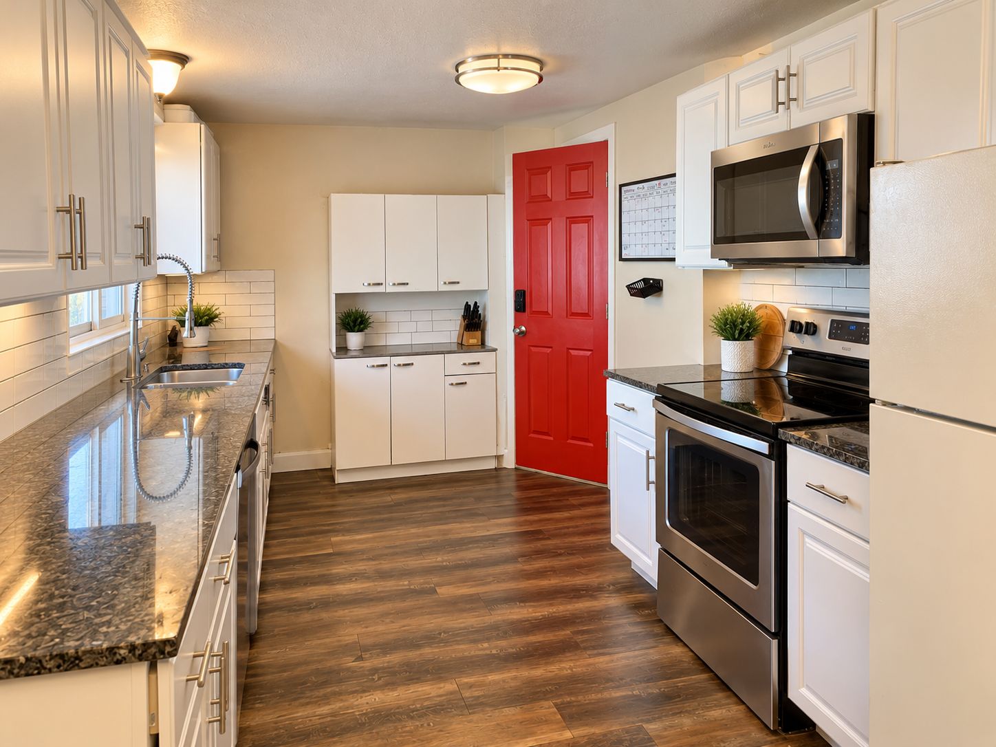 Galley kitchen with a red door