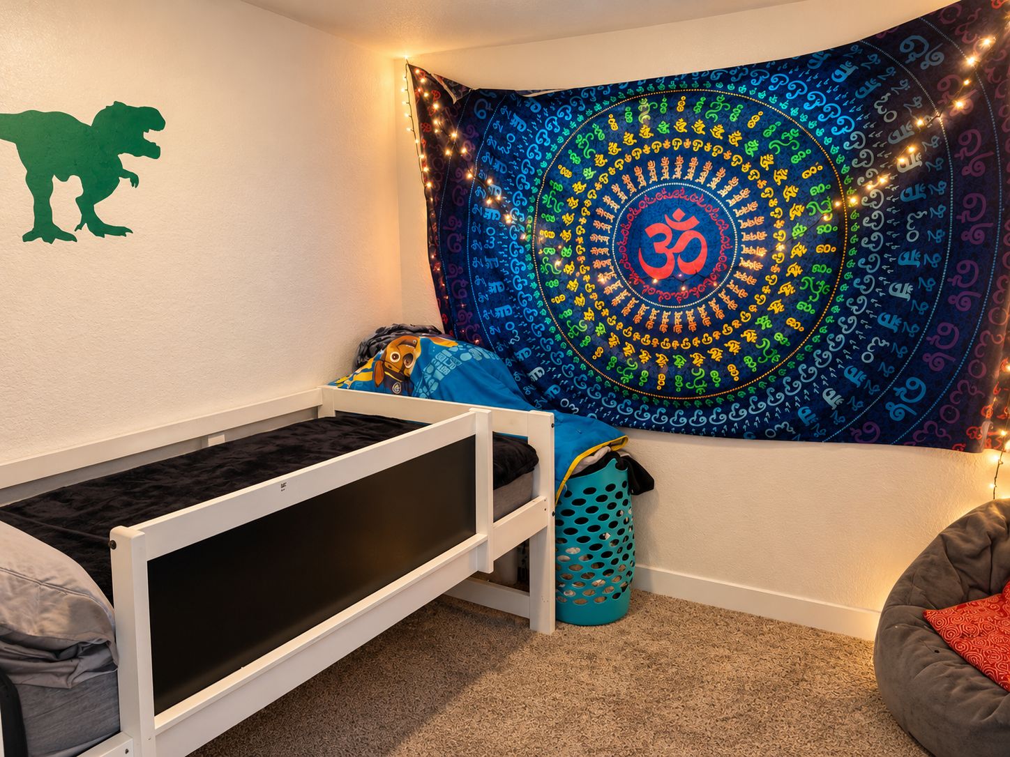Bedroom with a colorful wall hanging